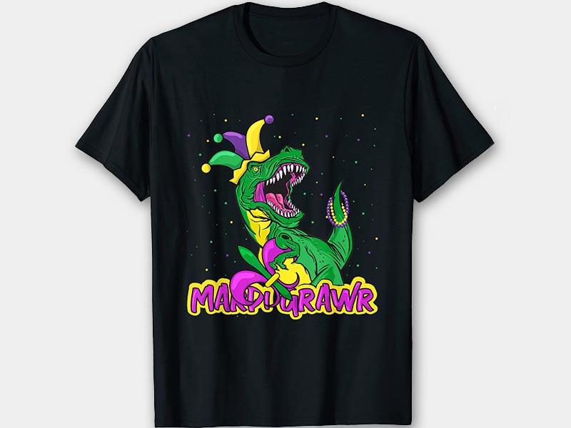 black shirt with T-Rex with jester hat and beads holding a fleur-de-lis and the words Mardi Grawr